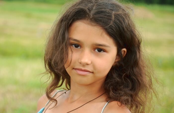 8 year old, brown haired girl in field
