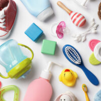 Flat lay composition with baby essentials on white background