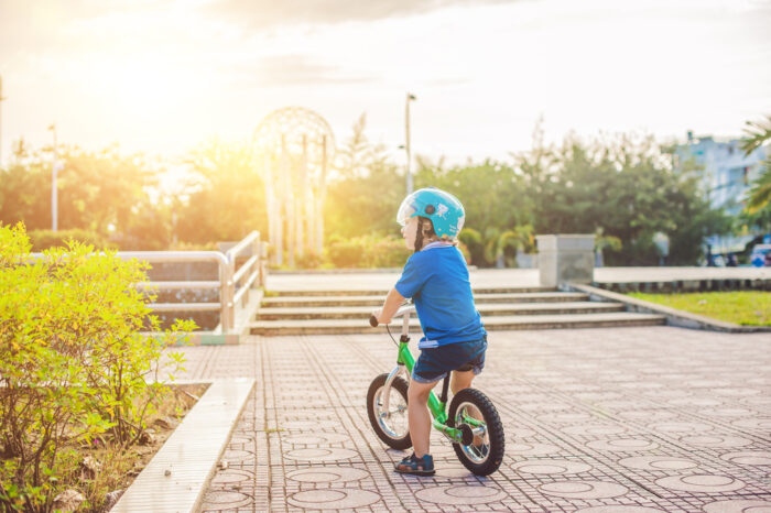 child riding on a balance bike