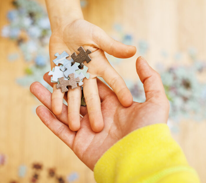 children holding puzzle pieces