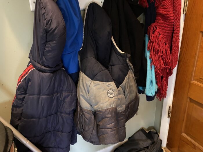 children winter coats hanging on the coat rack