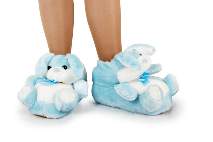 A child's legs in furry bunny slippers