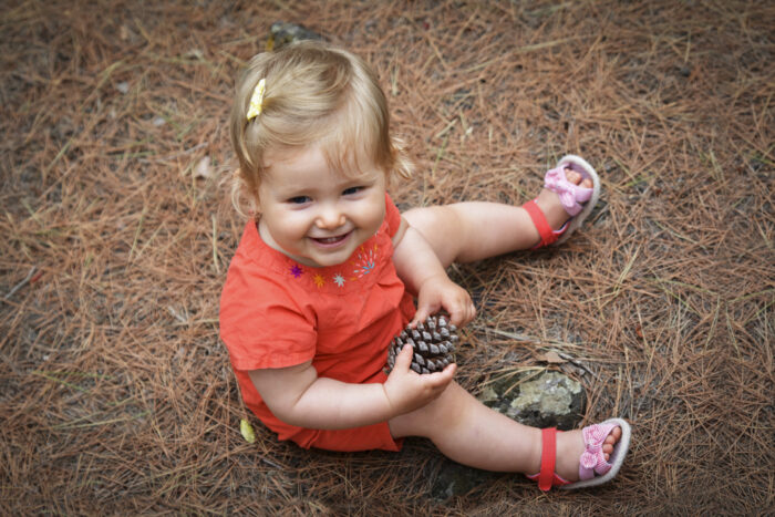 Toddler Sitting in Forest in Sandals